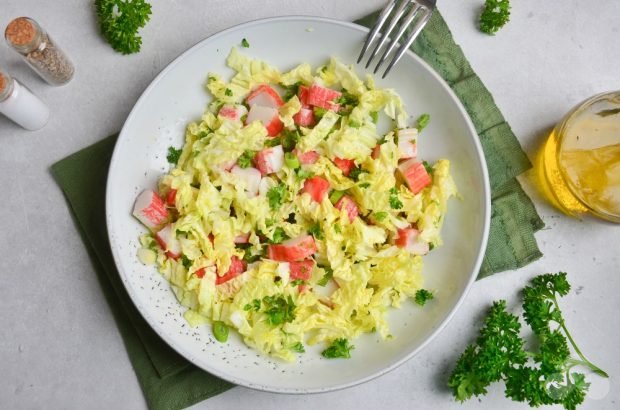 Salad with Peking cabbage, crab sticks and green onions