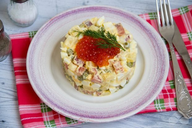 Salad with red fish, eggs, pineapple and green peas