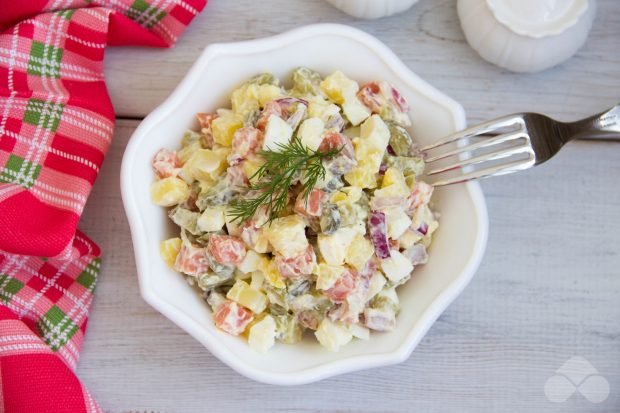 Salad of red fish, potatoes and pickled cucumbers