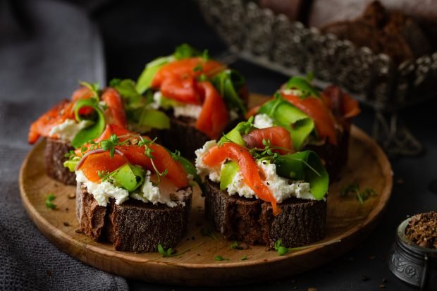 Bruschetta with red fish, avocado and cottage cheese