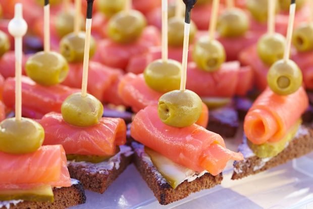 Canapes with salmon on skewers