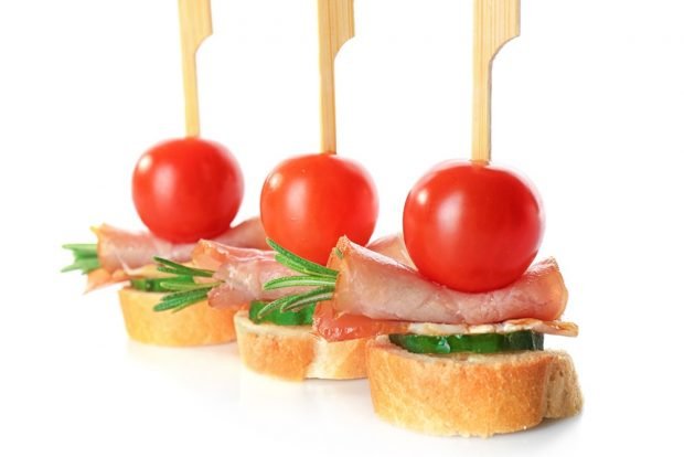 Canapes with smoked bacon on skewers