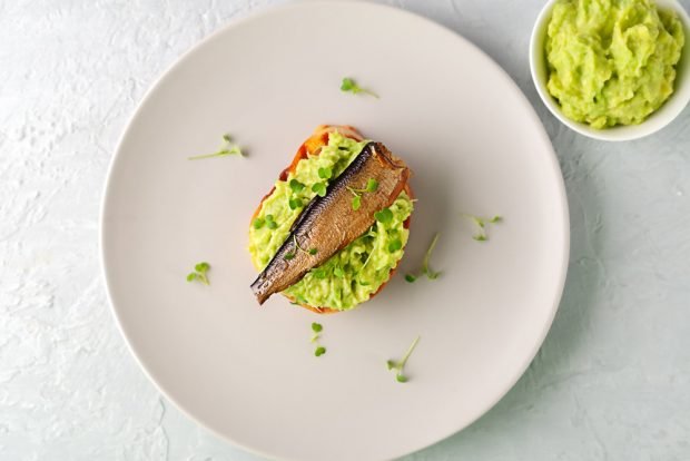 Sandwiches with sprats and avocado