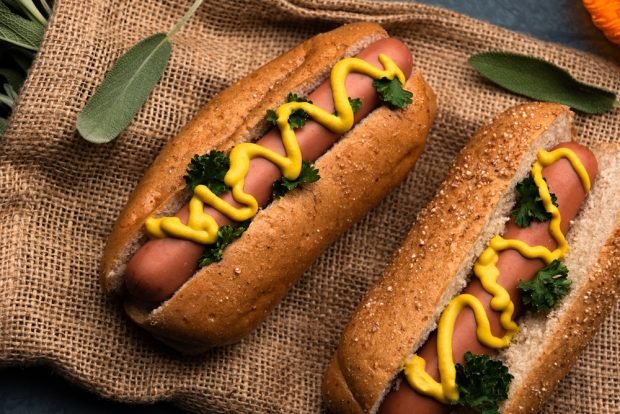 Hot dog with mustard and herbs