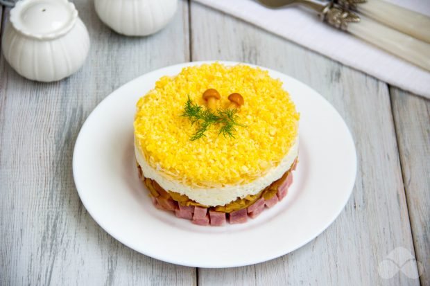 Puff salad with pickled mushrooms, ham, cheese and eggs