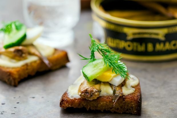 Sandwiches with sprats and cucumber for a festive table