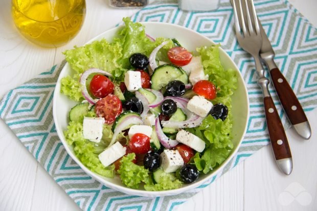 Greek salad with cheese, olives and iceberg lettuce