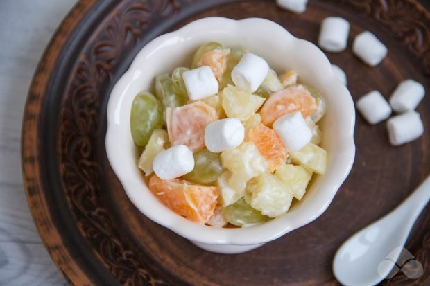 Fruit salad with pineapple, tangerines and marshmallows