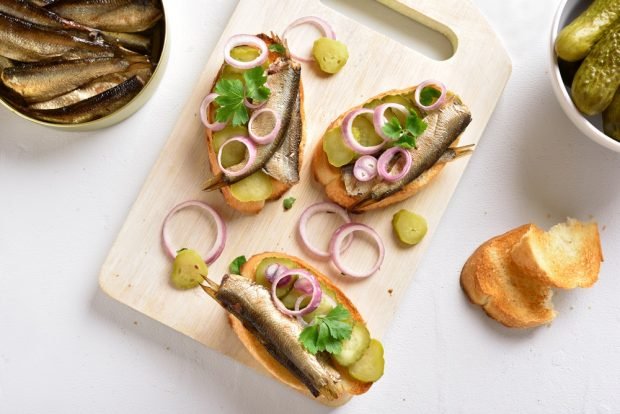 Sandwiches with sprats and baguette for the festive table