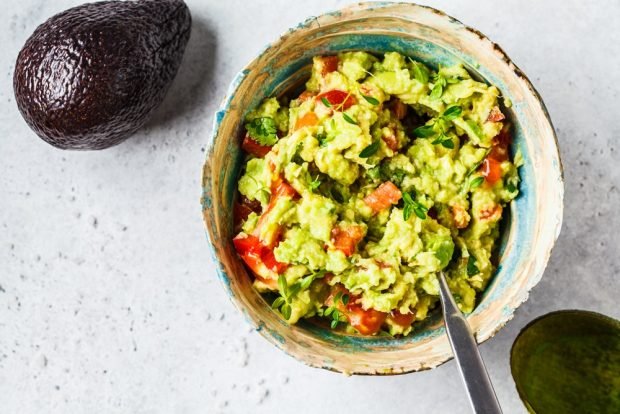 Classic guacamole with avocado, tomatoes and garlic