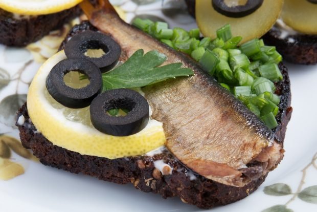 Sandwiches with sprats and black bread for the festive table