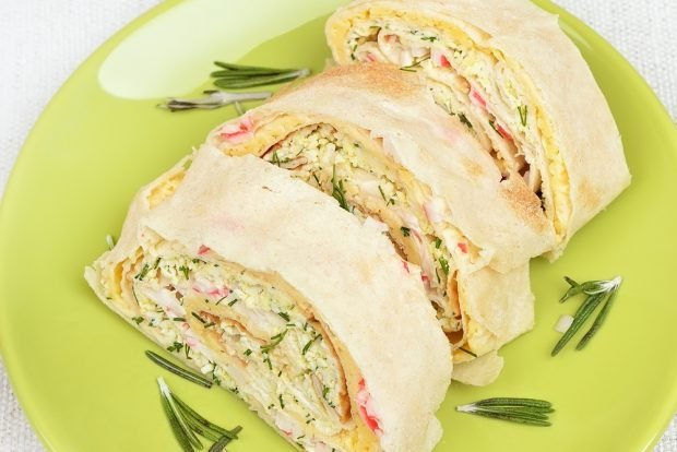 Pita bread roll with crab sticks, cheese and garlic 