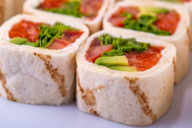 Pita bread roll with tomatoes and herbs 