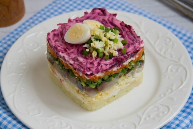 Herring under a fur coat with quail eggs