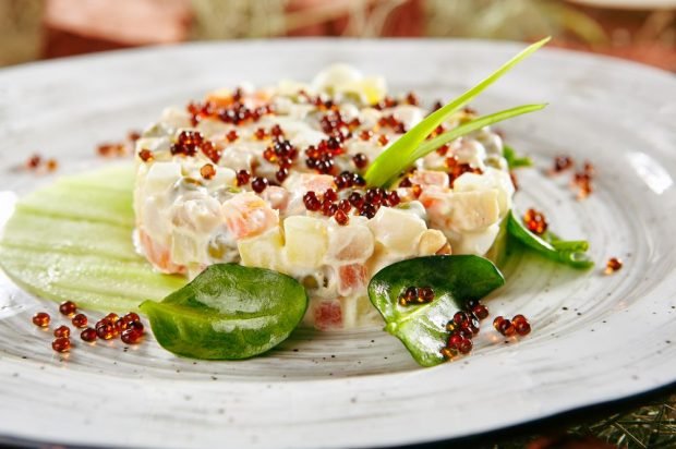 Salad with red fish, pickles and potatoes