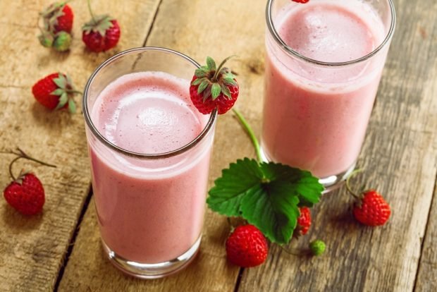 Strawberry cocktail in a blender with milk 