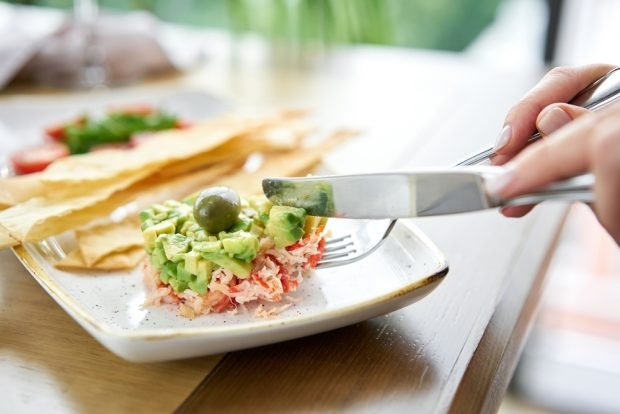 Salad with crab meat, avocado and quail eggs