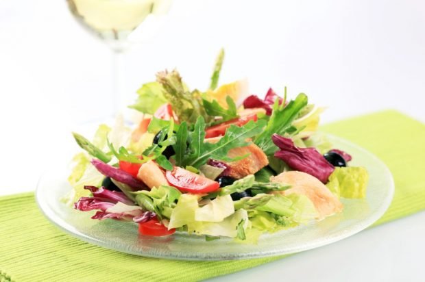 Meat salad of chicken, asparagus, tomatoes and fresh herbs 