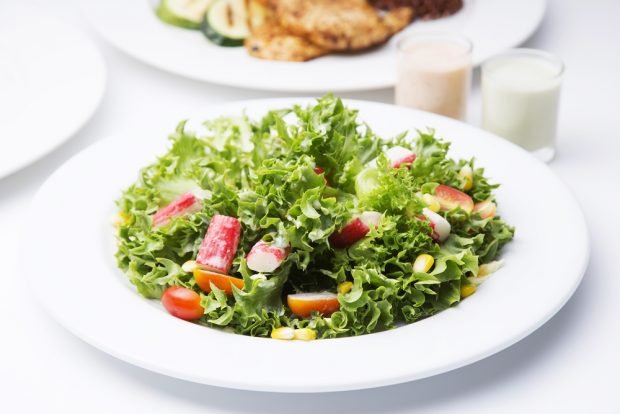 Salad with lettuce, crab sticks and cherry