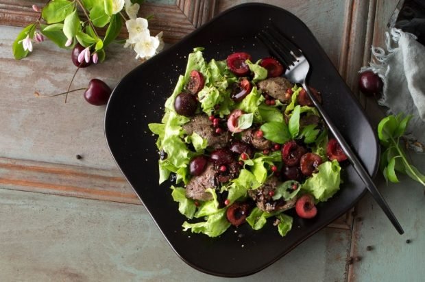 Exquisite salad with chicken liver, cherries and herbs