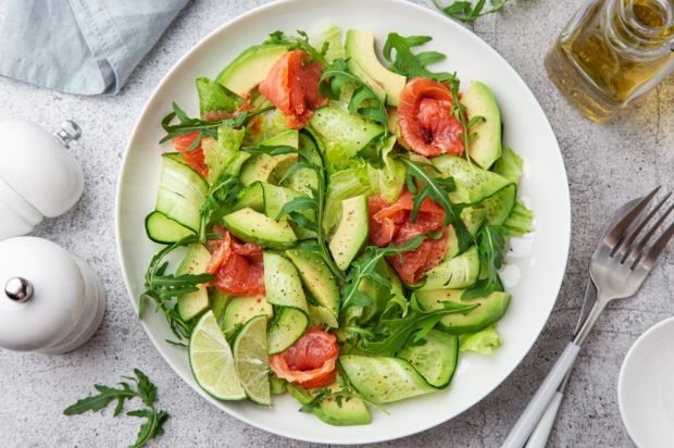 Fresh salad with avocado, herbs and red fish 