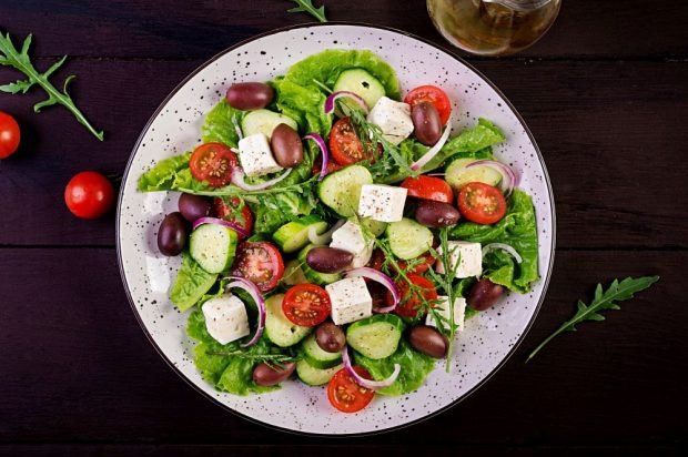 Greek salad with feta, arugula and purple onion