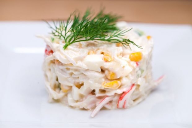 Salad of crab sticks, squid and processed cheese 