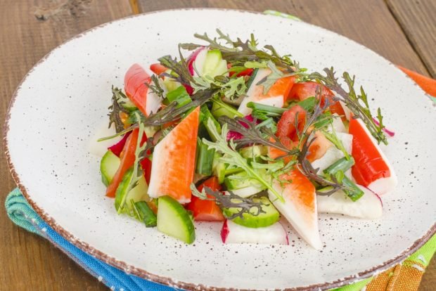 Fresh vegetable salad with crab sticks 