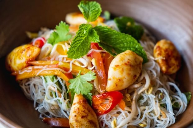 Salad of funchosa, squid, bell pepper and sprouts 