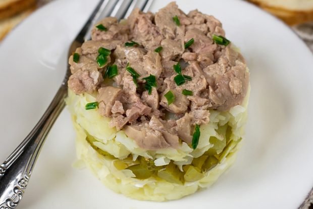 Puff salad with cod liver and gherkins