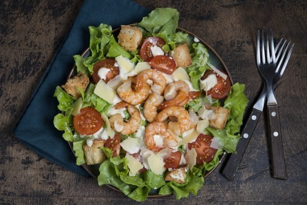 Caesar salad with shrimp and cherry 