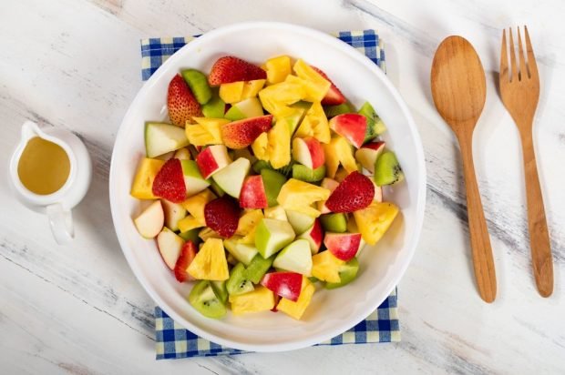 Fruit salad of pineapples, strawberries, kiwi and apples 