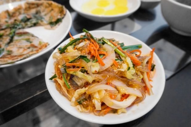 Salad of funchosa, squid, Peking cabbage and carrots