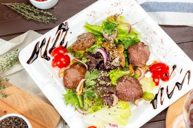 Meat salad of beef, vegetables and fried mushrooms