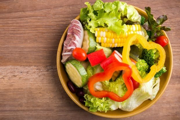 Salad bowl with vegetables and crab sticks 