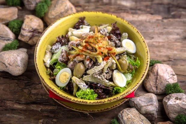 Salad with mushrooms, olives and pickled cucumbers