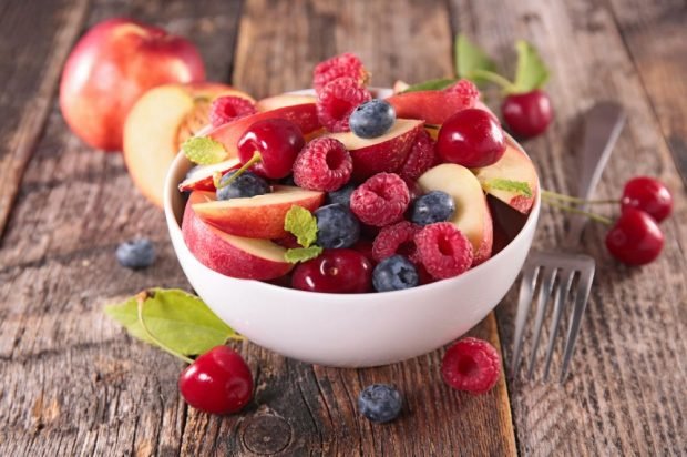 Fruit salad of apples, raspberries, blueberries and cherries 