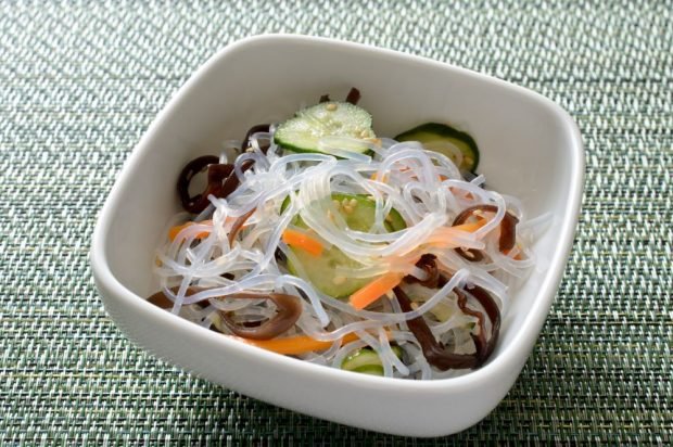 Salad of funchosa, wood mushrooms, cucumbers and carrots