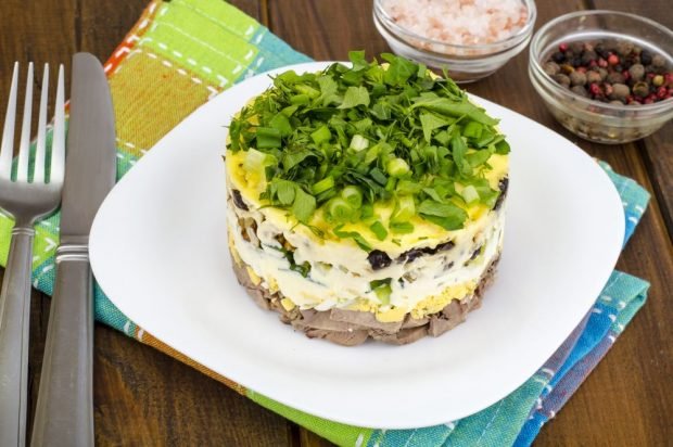 Puff salad with beef, fried mushrooms, cucumbers and eggs