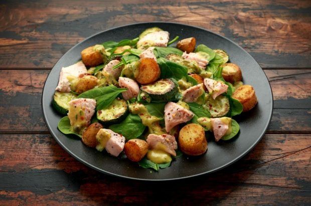 Salad with boiled red fish, fried zucchini and potatoes 