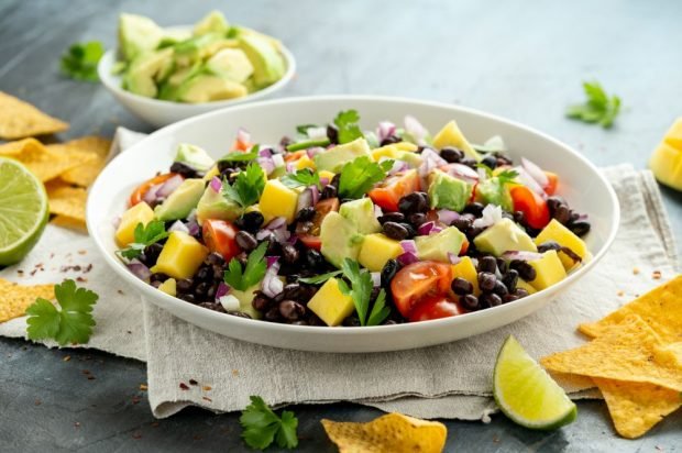 Exotic salad with red beans, mango, avocado and tomatoes