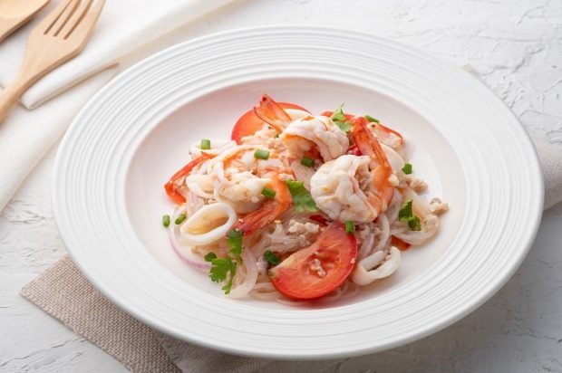 Asian seafood salad, funchosa and tomatoes