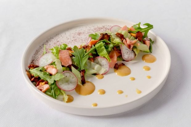 Salad with fried red fish, mushrooms and radishes