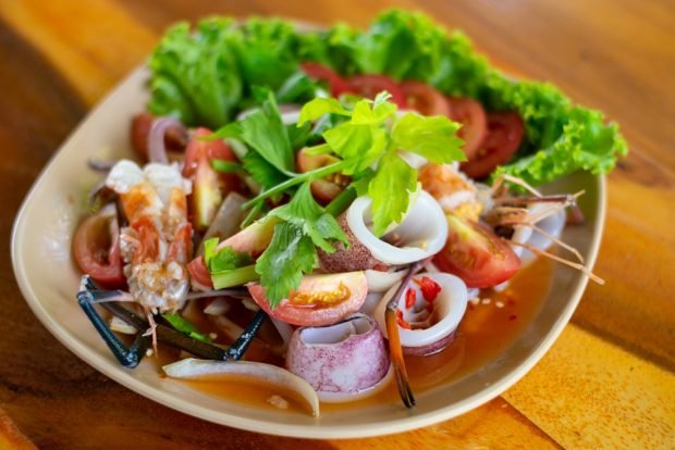 Sea salad with tomatoes and chili