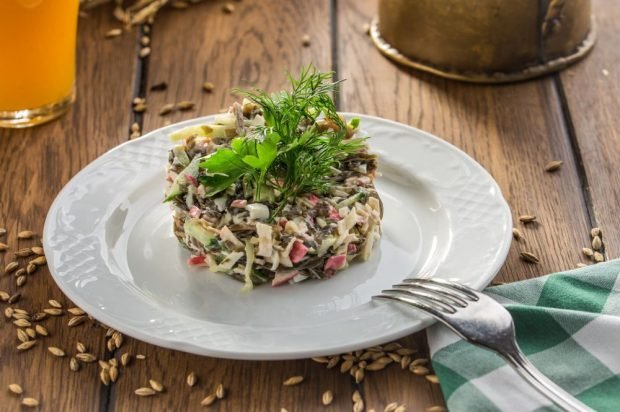 Seaweed salad with eggs, crab sticks and cucumber