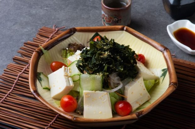 Salad of seaweed, cheese, cucumbers and cherry tomatoes