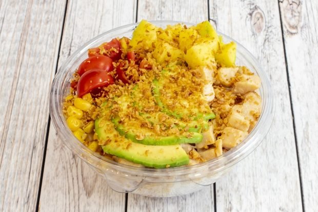 Salad bowl with chicken, avocado and pineapples