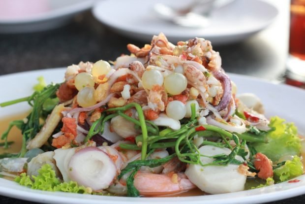 Salad with sea cocktail and herbs