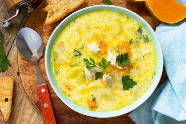 Soup with turkey, pumpkin and melted cheese 