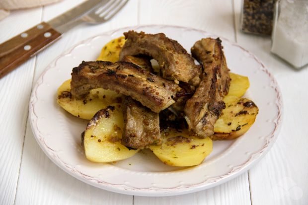 Pork ribs with potatoes in the oven in foil